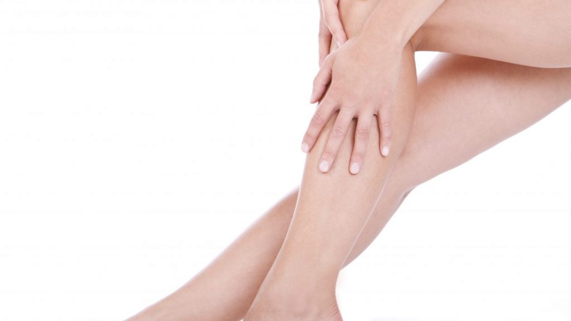 Woman applying moisturizer cream on the legs